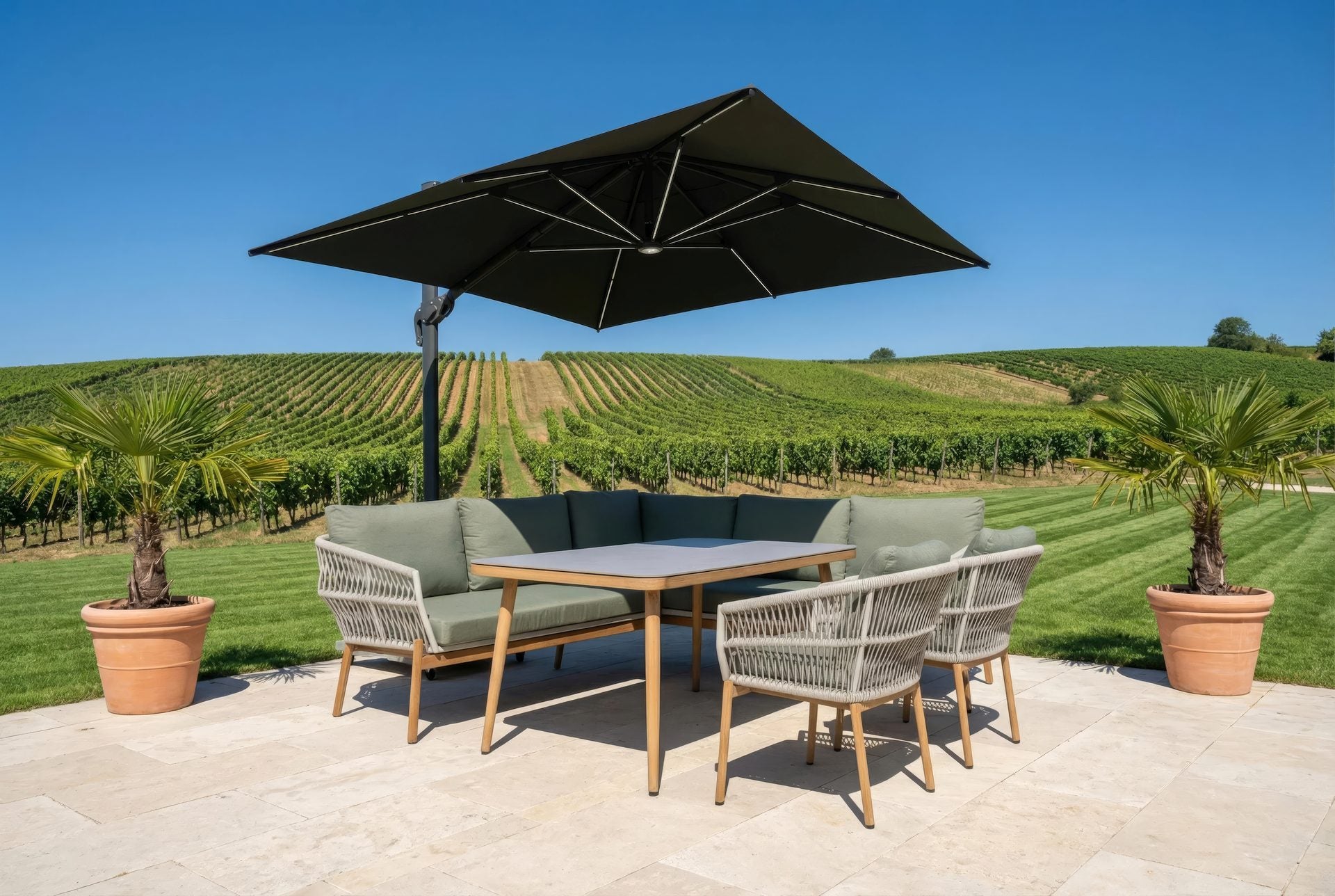 Alicia Garten Eckbankgruppe mit grauer Sinterstein-Tischplatte und grünen Kissen auf robustem Aluminiumgestell in Holzoptik.